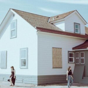 a couple of people standing in front of a house